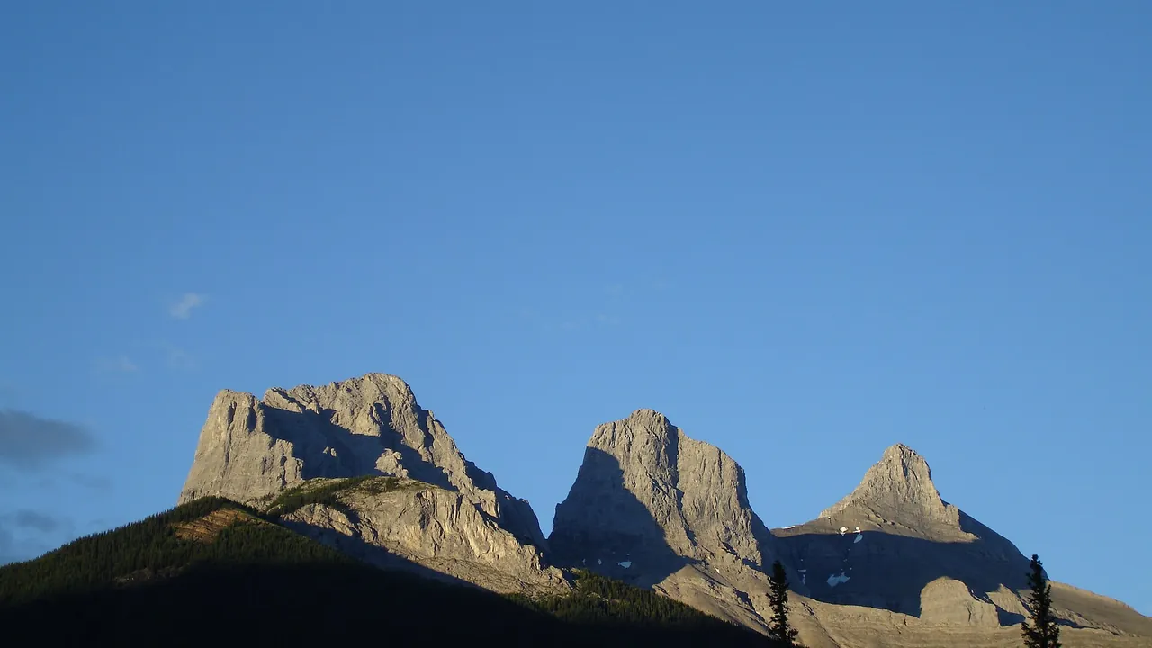 Three Sisters peaks above downtown Canmore in Canmore, Alberta